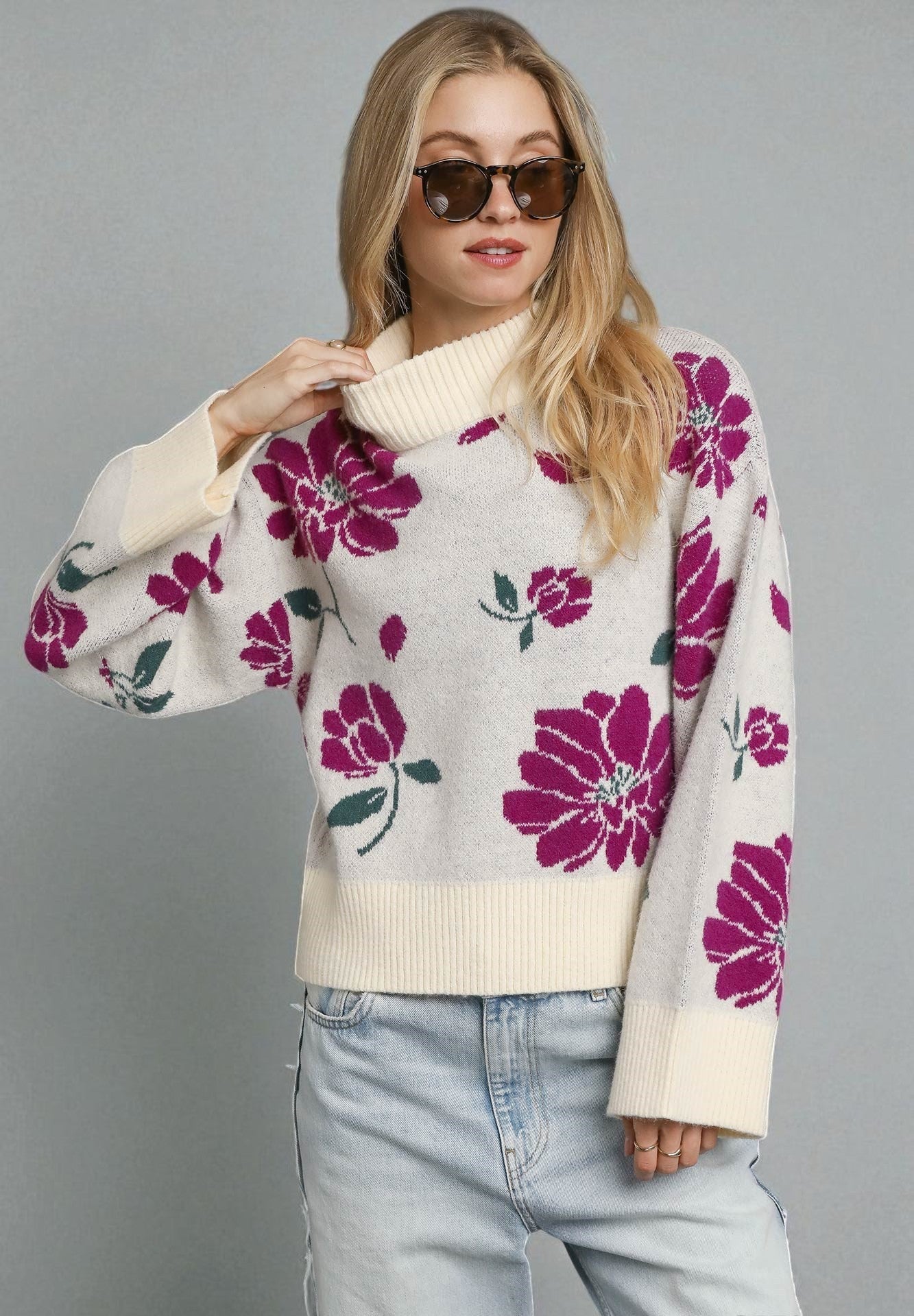 Woman wearing a floral sweater with a gray background