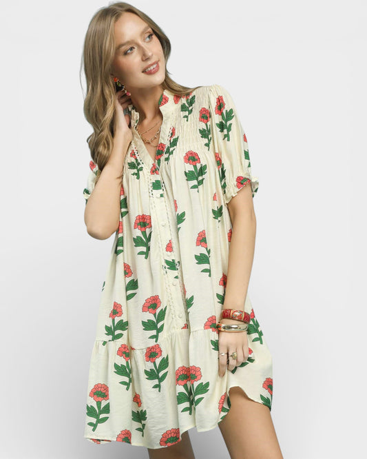 Woman wearing a floral dress on a plain background