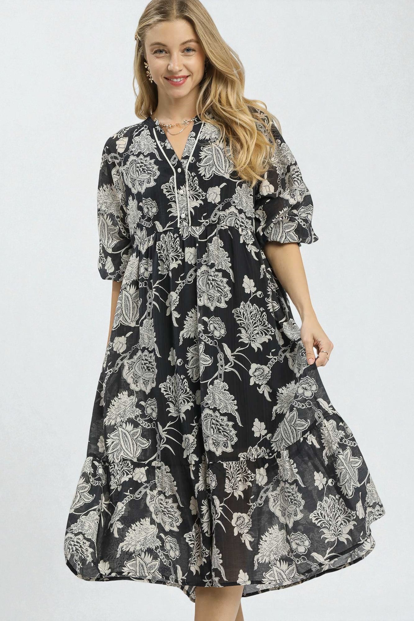 Woman wearing a black floral dress on a white background