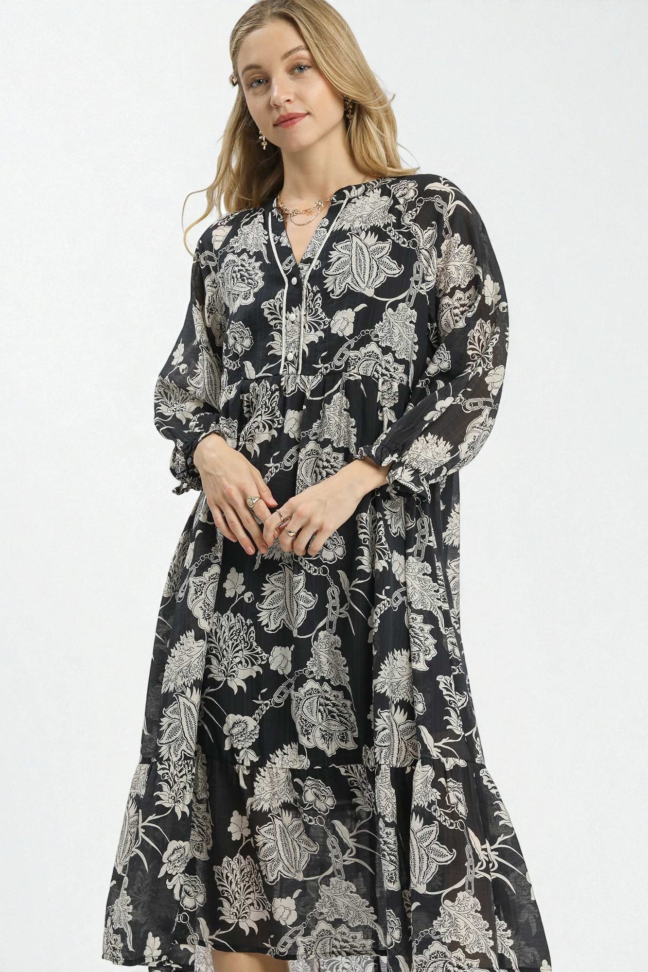 Woman wearing a black floral dress on a white background