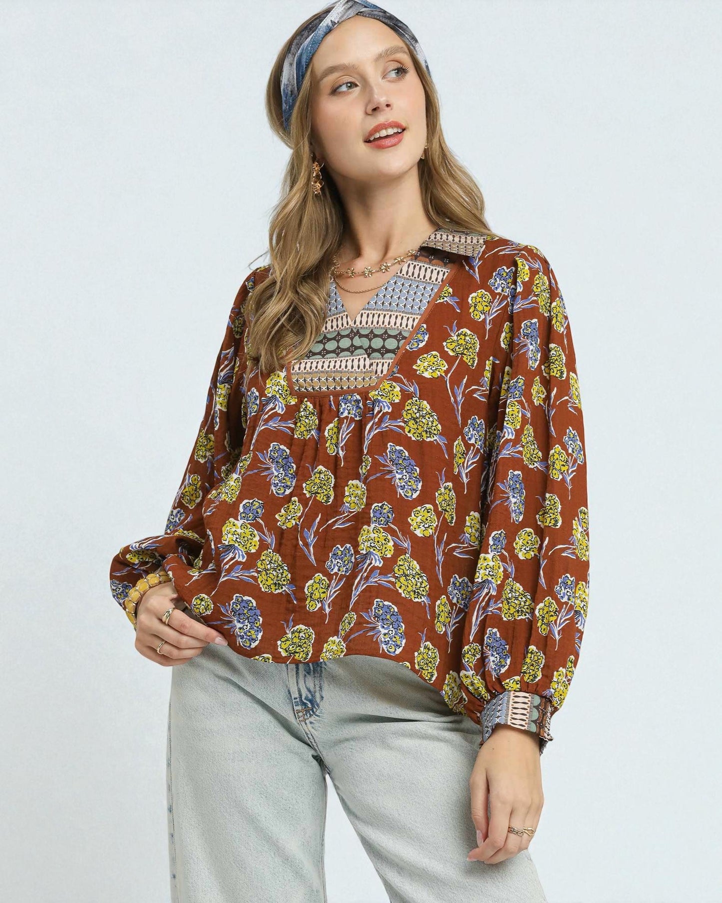 Woman wearing a floral blouse with a plain background