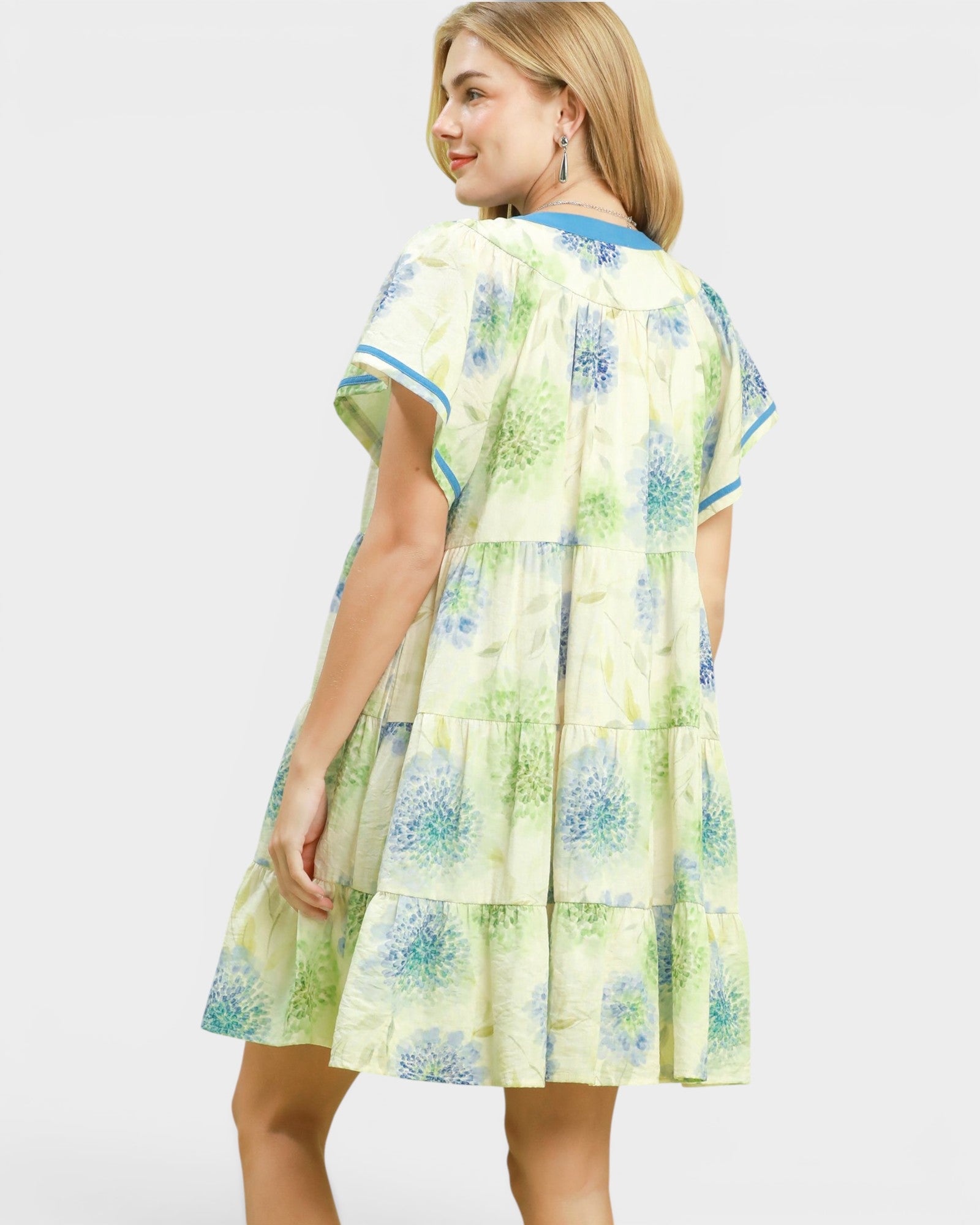 Woman wearing a floral dress with a white background