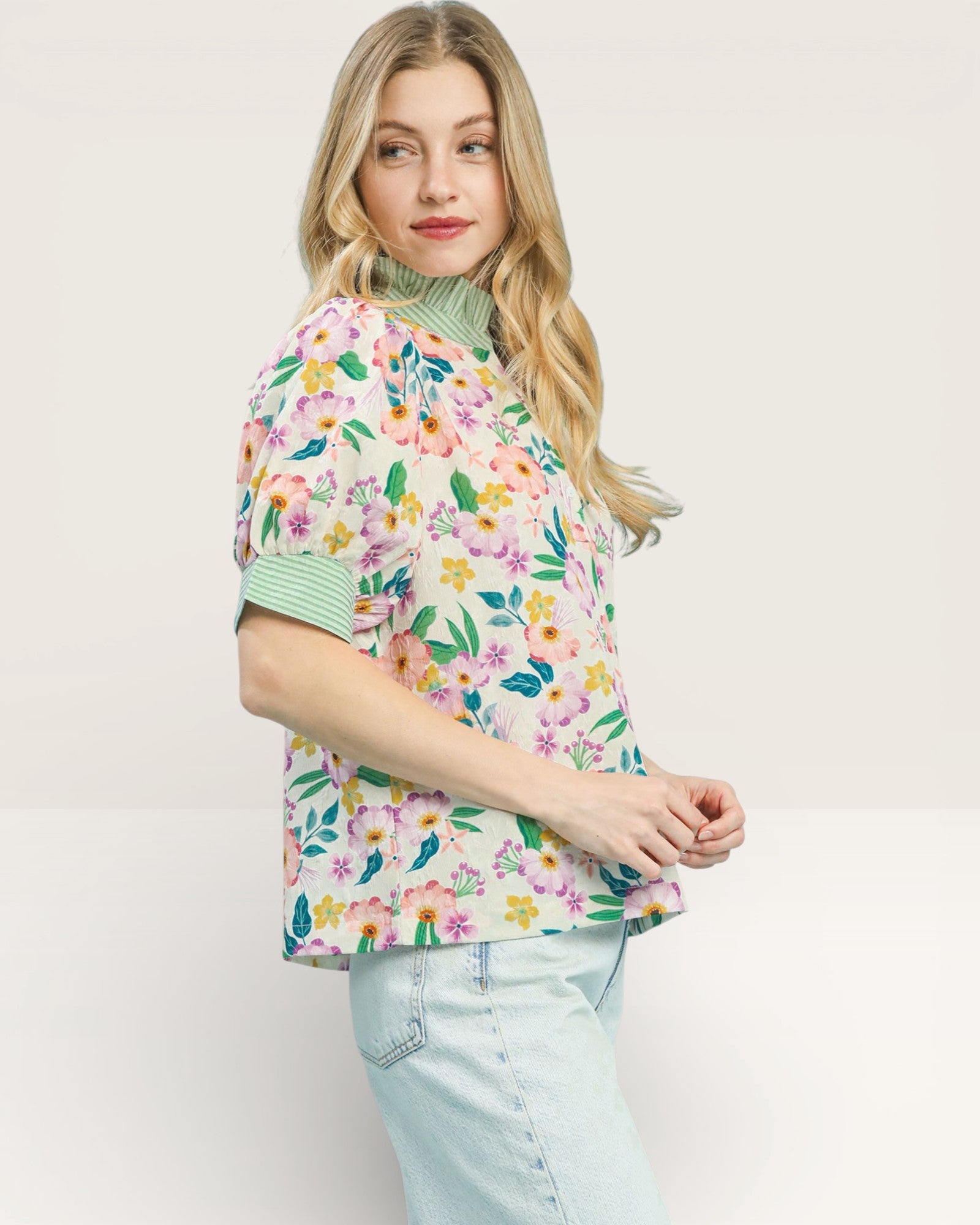 Woman wearing a floral blouse with a plain background