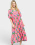 Woman wearing a pink floral dress on a white background