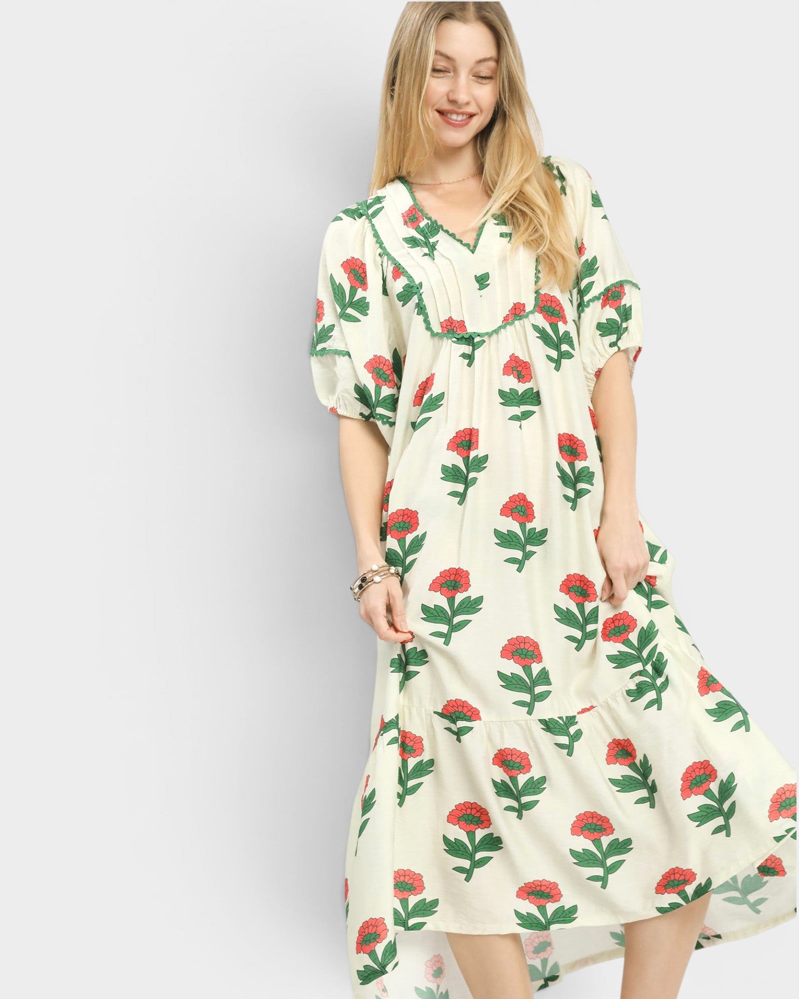 Woman wearing a floral dress against a plain background