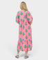 Woman wearing a pink floral dress on a white background