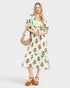 Woman wearing a floral dress with a beige background