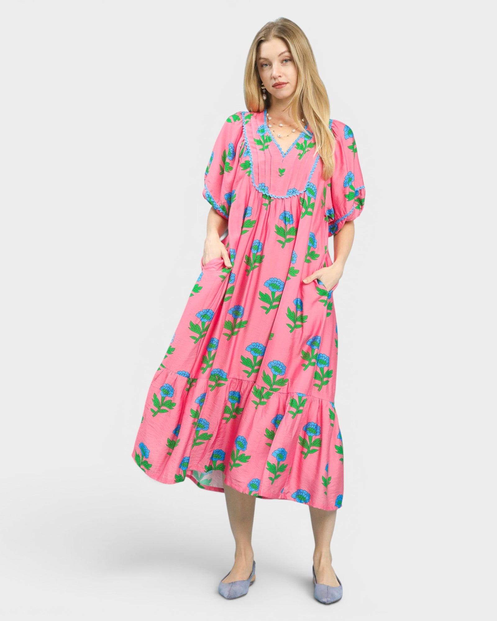 Woman wearing a pink floral dress on a white background