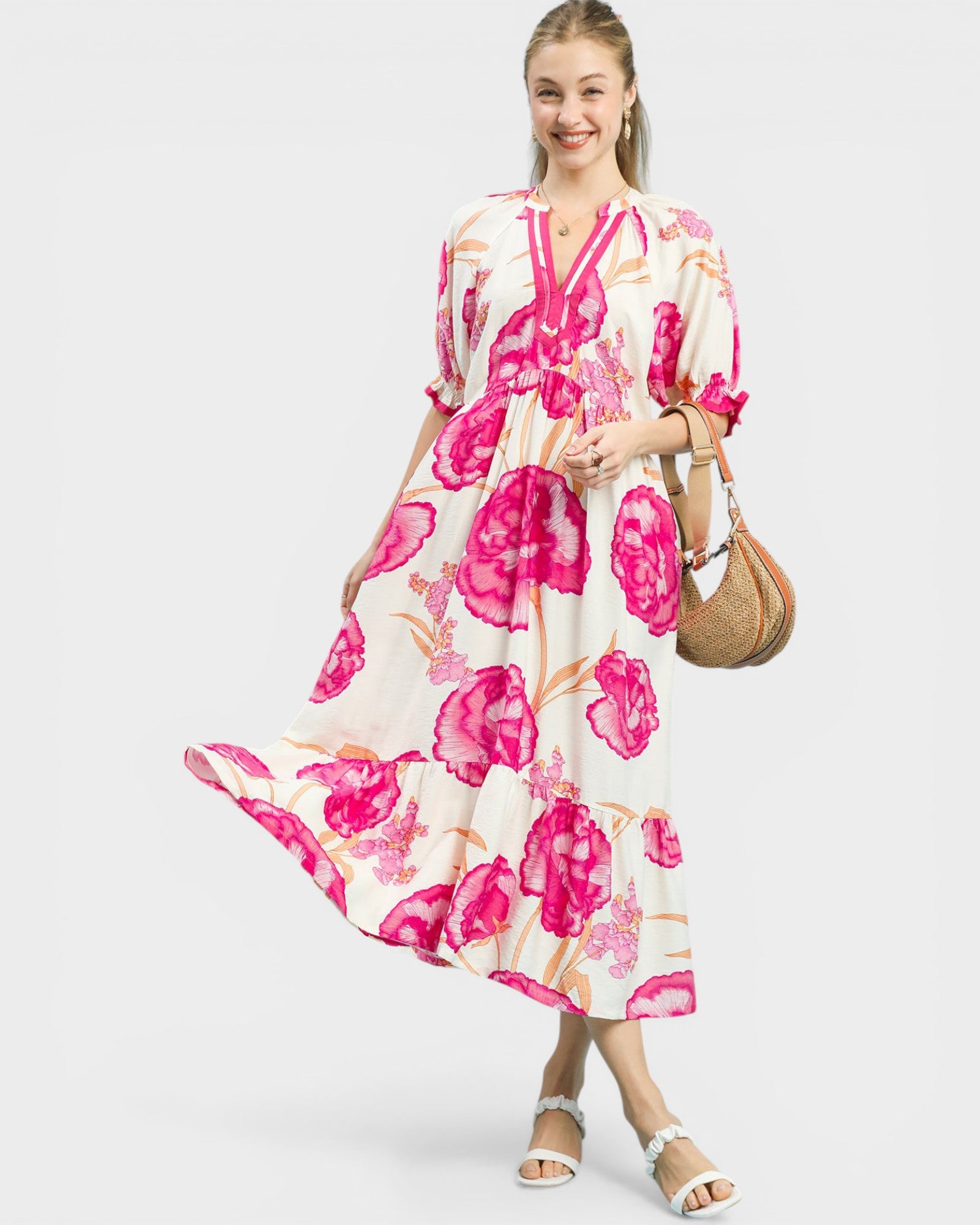 Woman wearing a floral dress with pink flowers on a white background