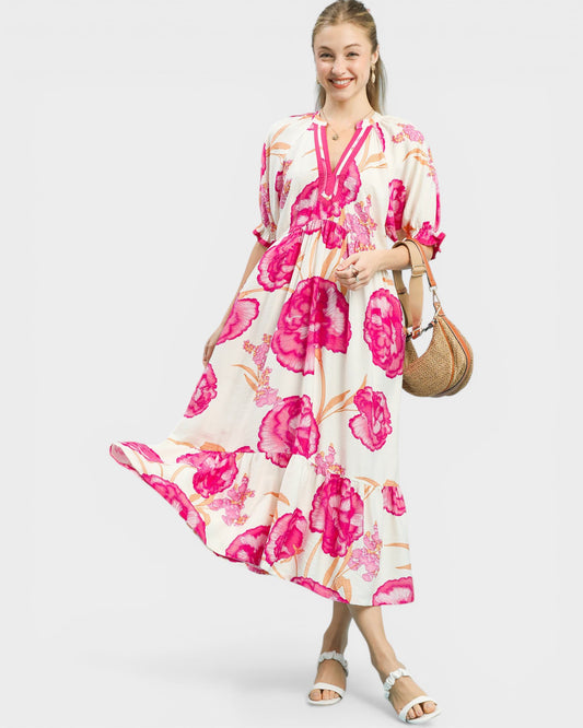 Woman wearing a floral dress with pink flowers on a white background