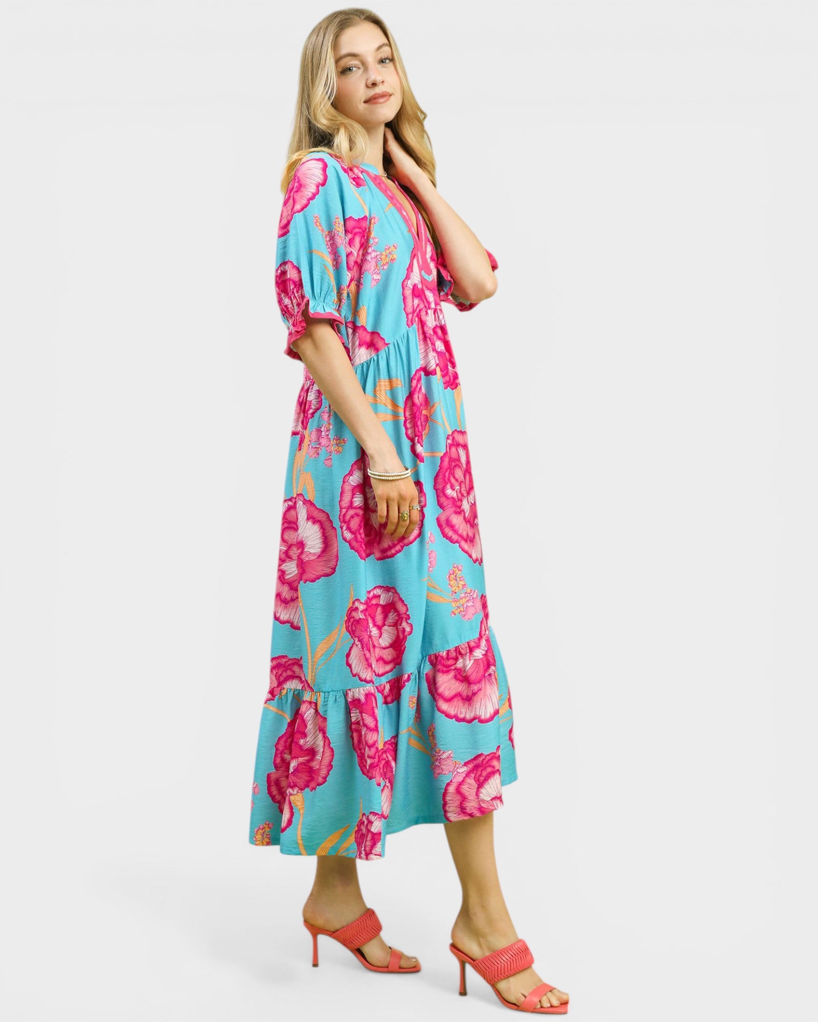 Woman wearing a blue floral dress on a white background