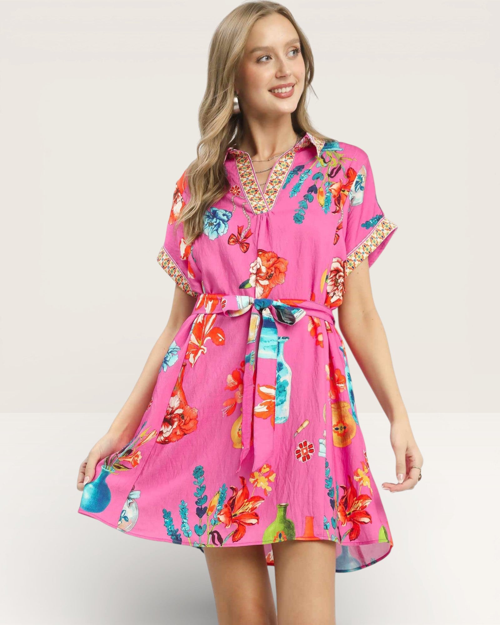 Woman wearing a pink floral dress on a white background