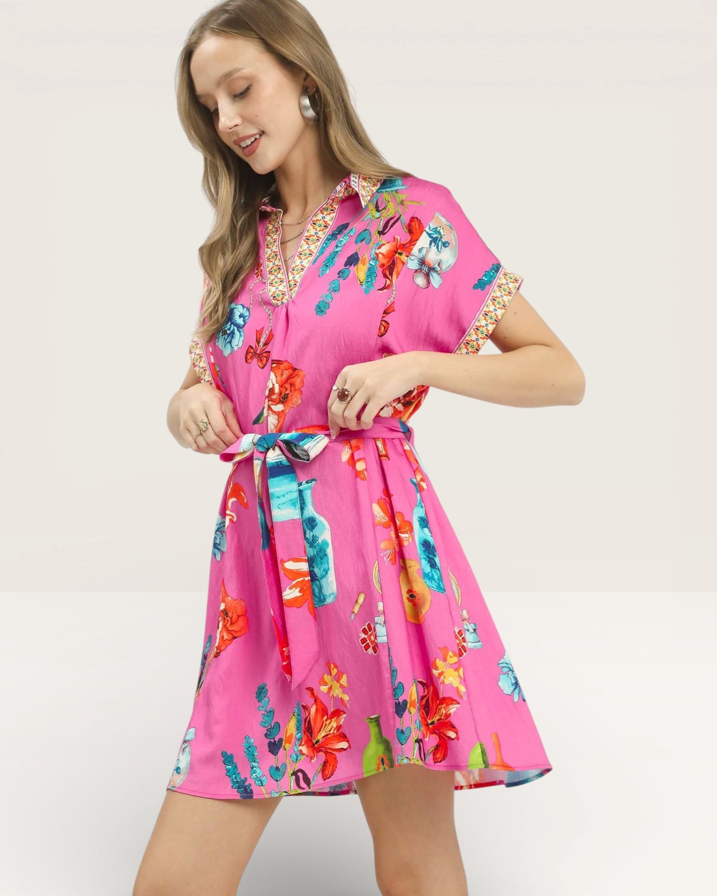 Woman wearing a pink floral dress on a white background
