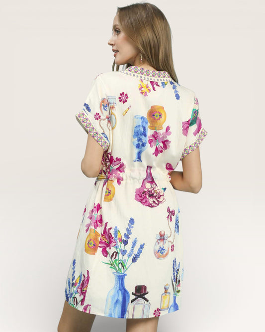 Woman wearing a colorful floral dress with a white background