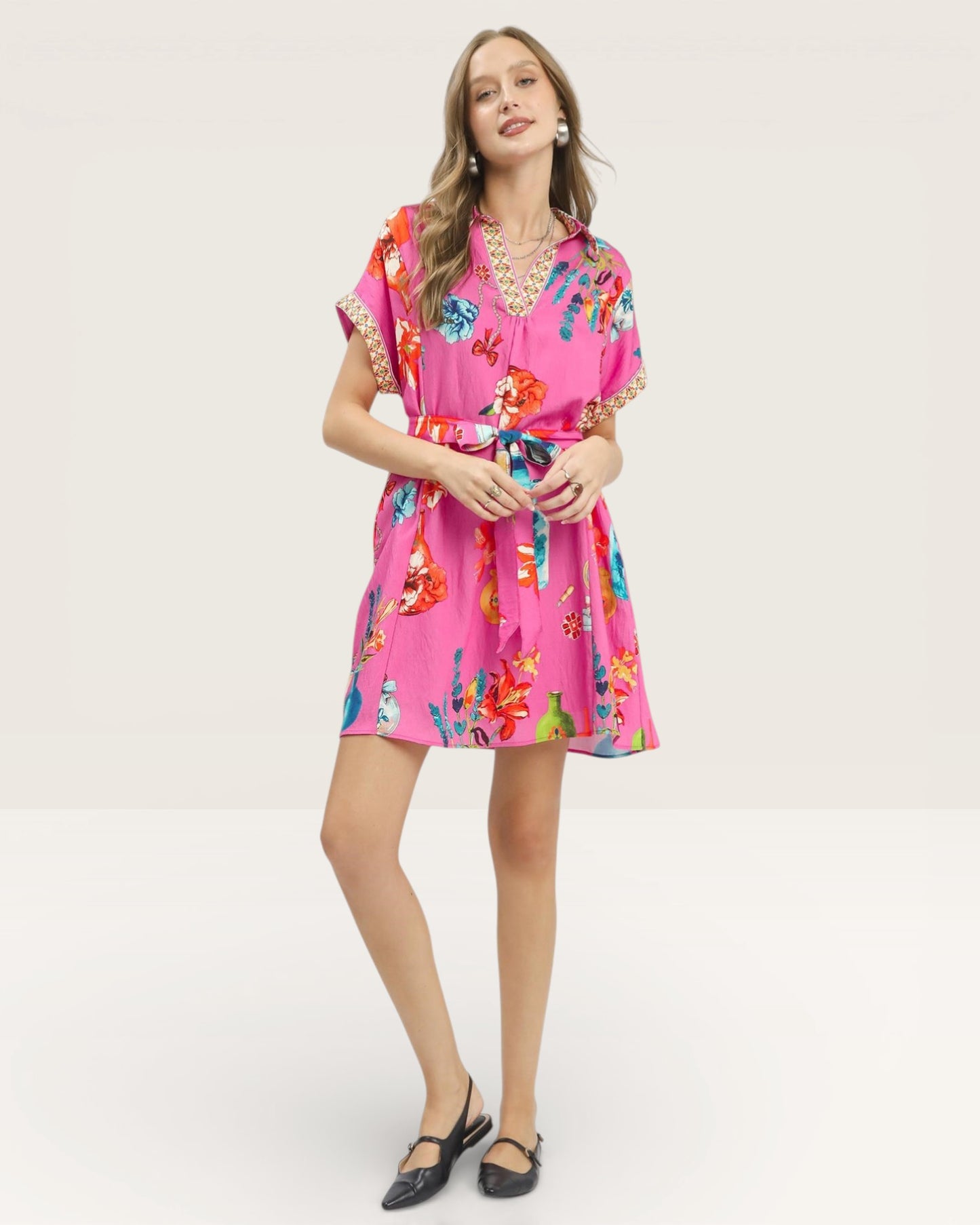 Woman wearing a pink floral dress on a white background
