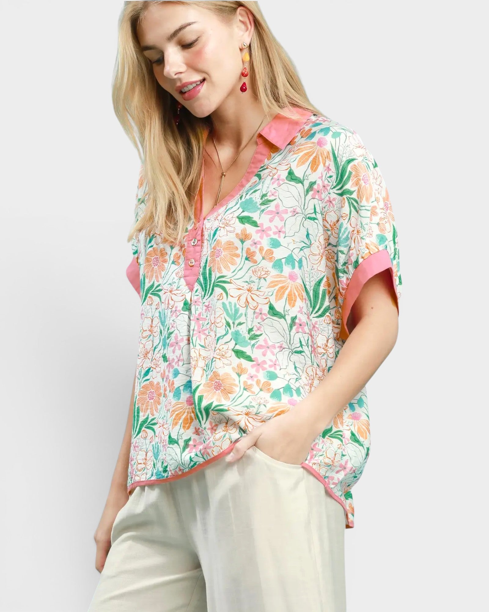 Woman wearing a floral blouse with a plain background