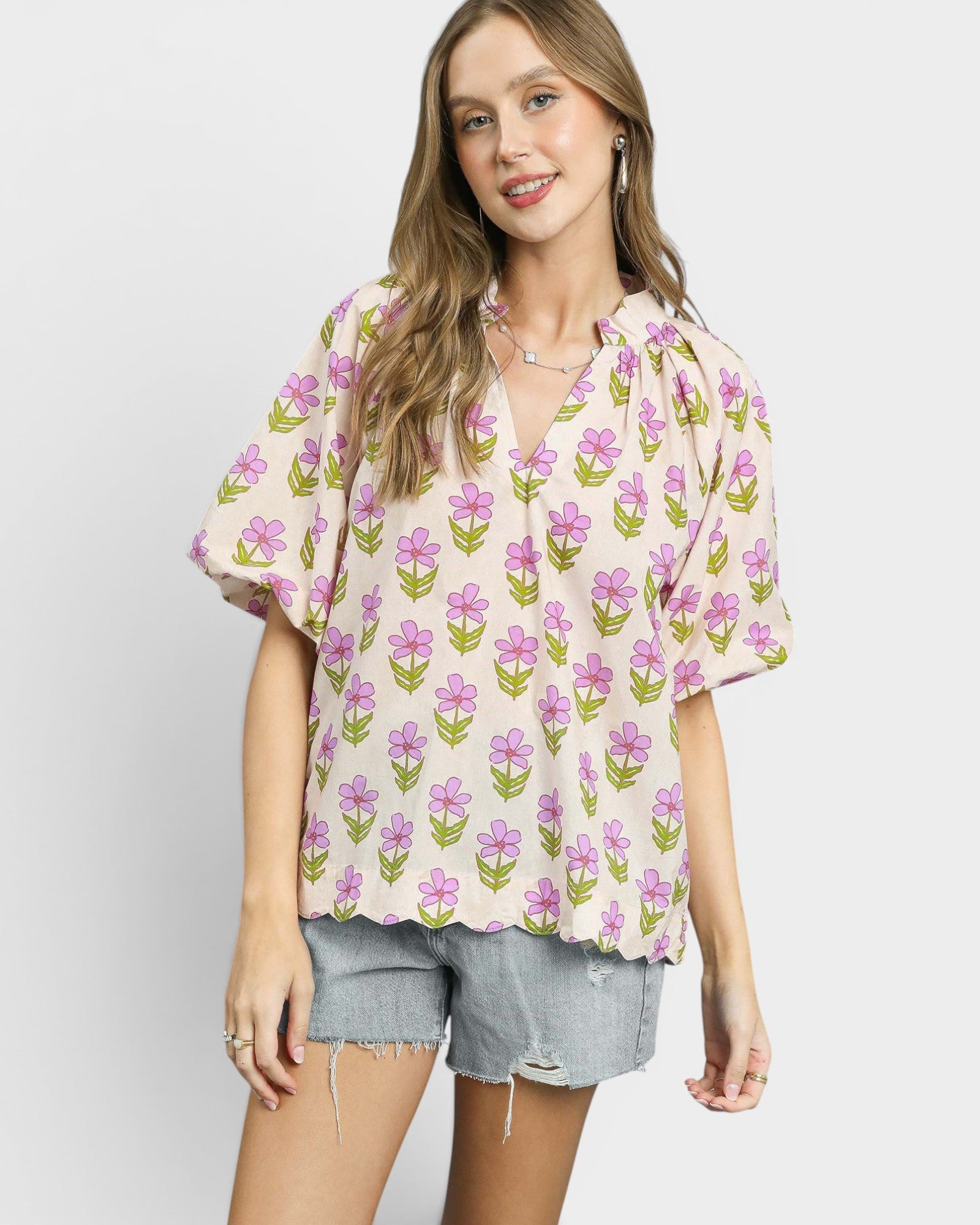 Woman wearing a floral blouse with a plain background