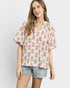 Woman wearing a floral blouse with a plain background