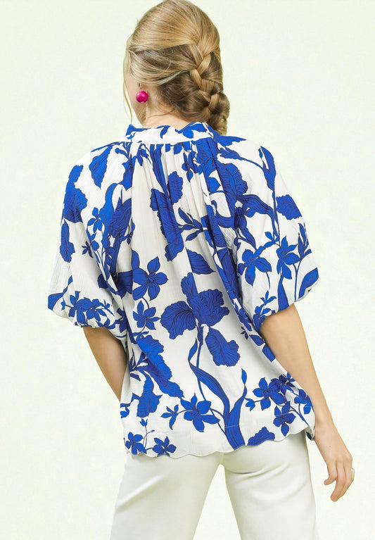 Woman wearing a blue floral blouse on a white background