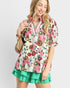 Woman wearing a colorful floral dress with a white background