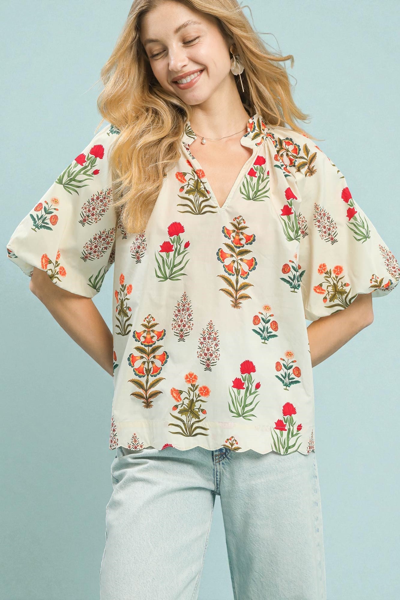 Woman wearing a floral blouse with a light blue background