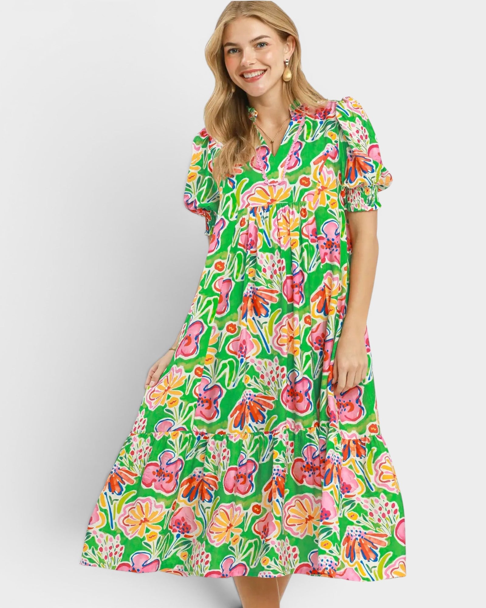 Woman wearing a colorful floral dress on a white background