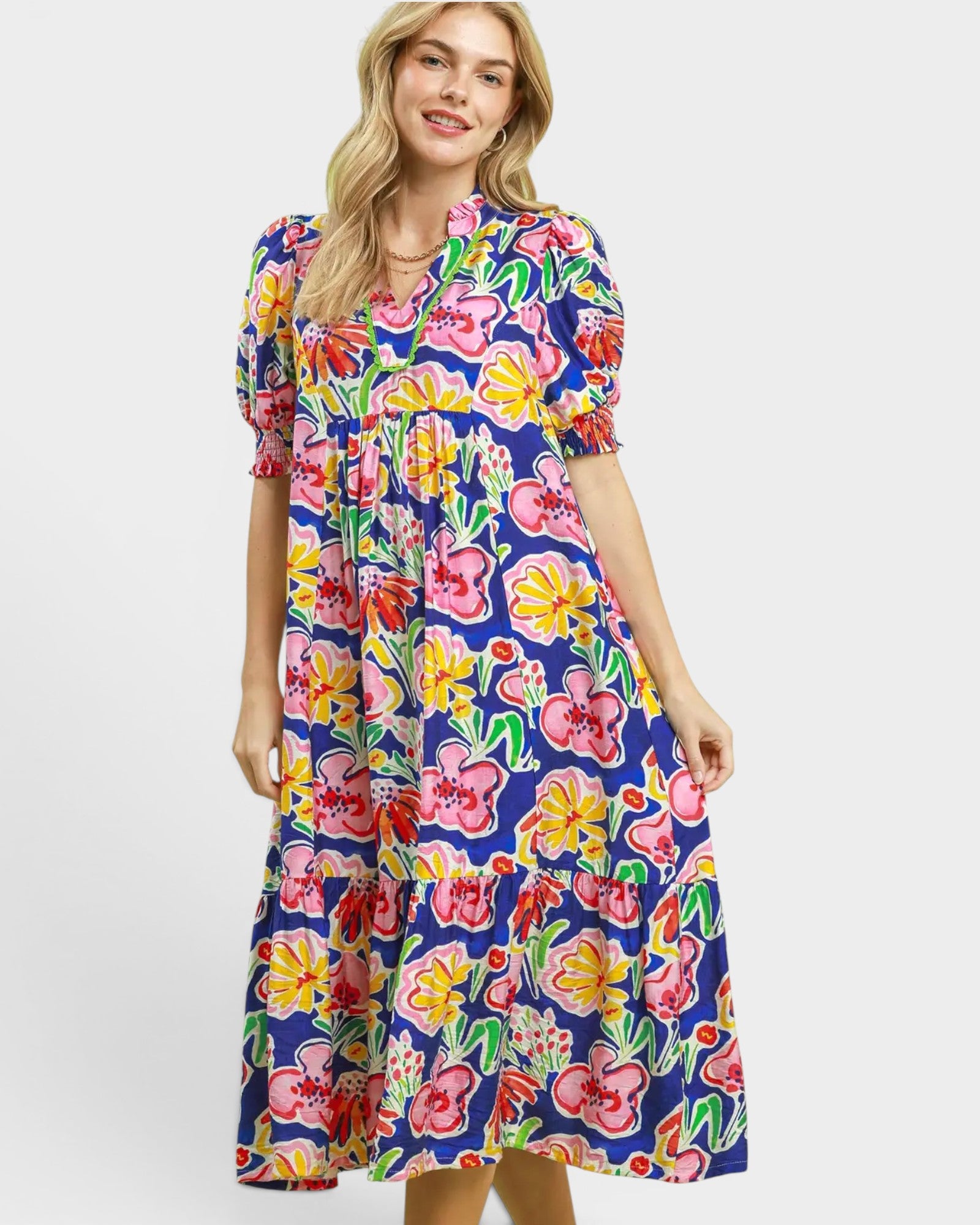 Woman wearing a colorful floral dress on a white background