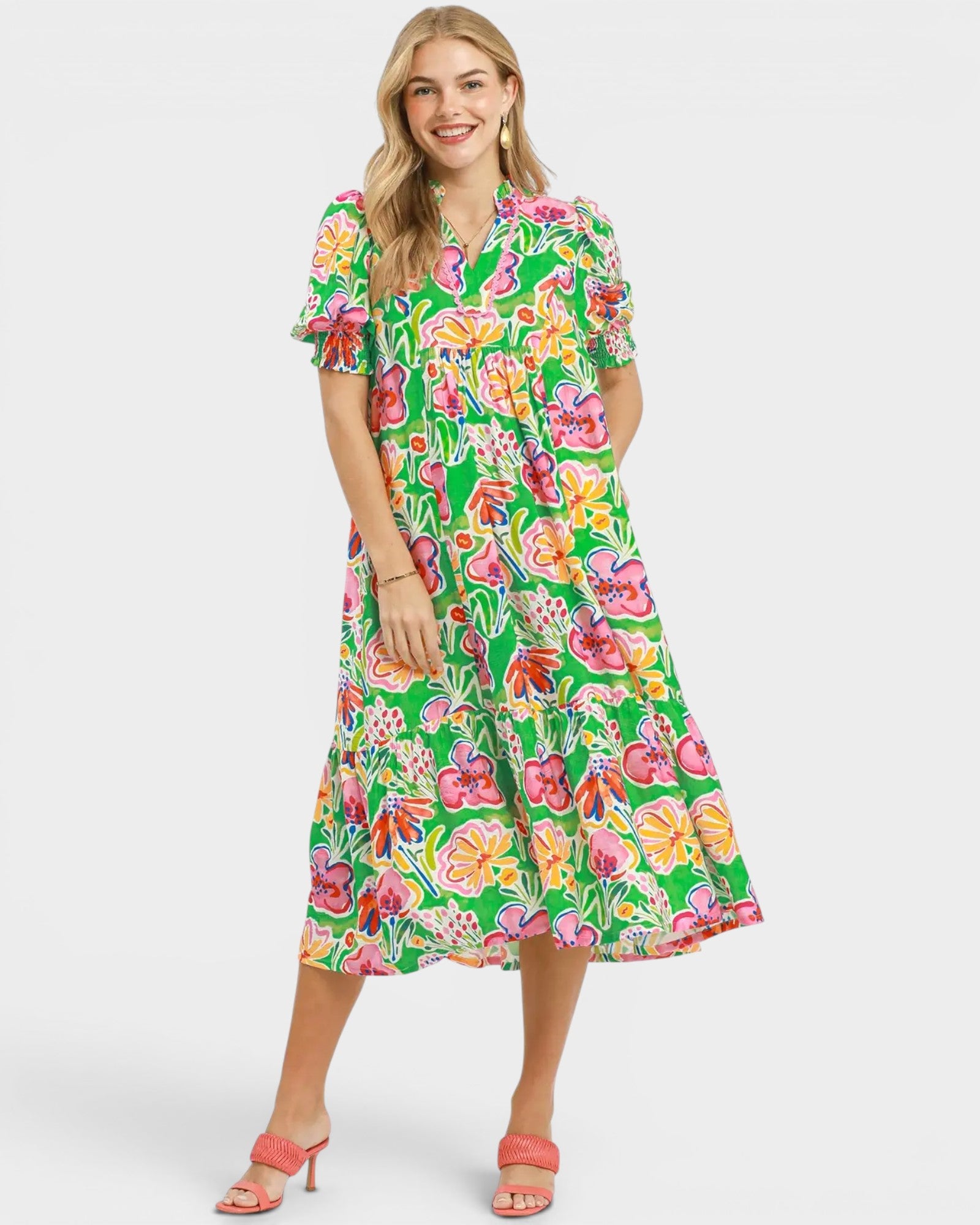 Woman wearing a colorful floral dress on a white background