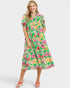 Woman wearing a colorful floral dress on a white background
