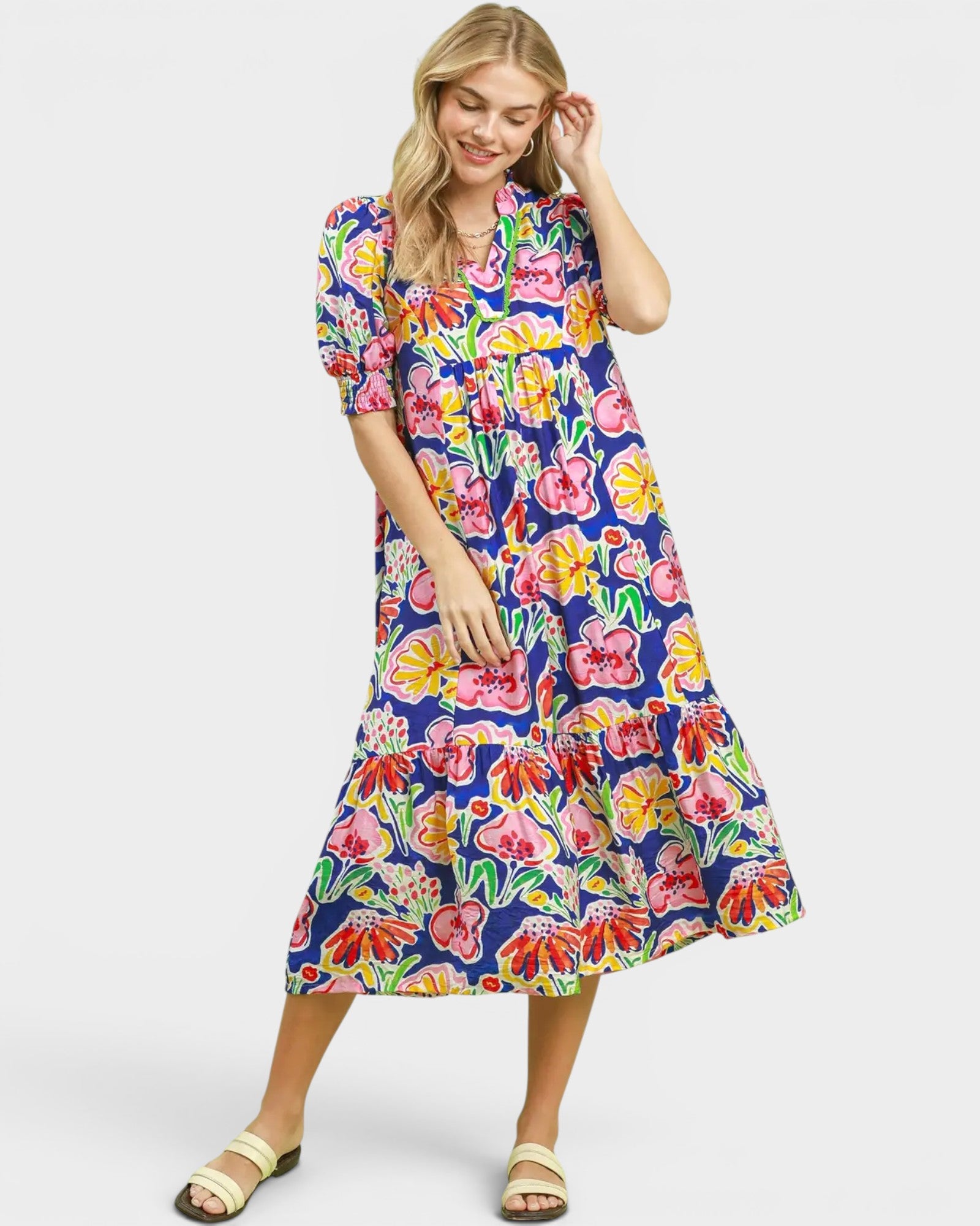 Woman wearing a colorful floral dress on a white background
