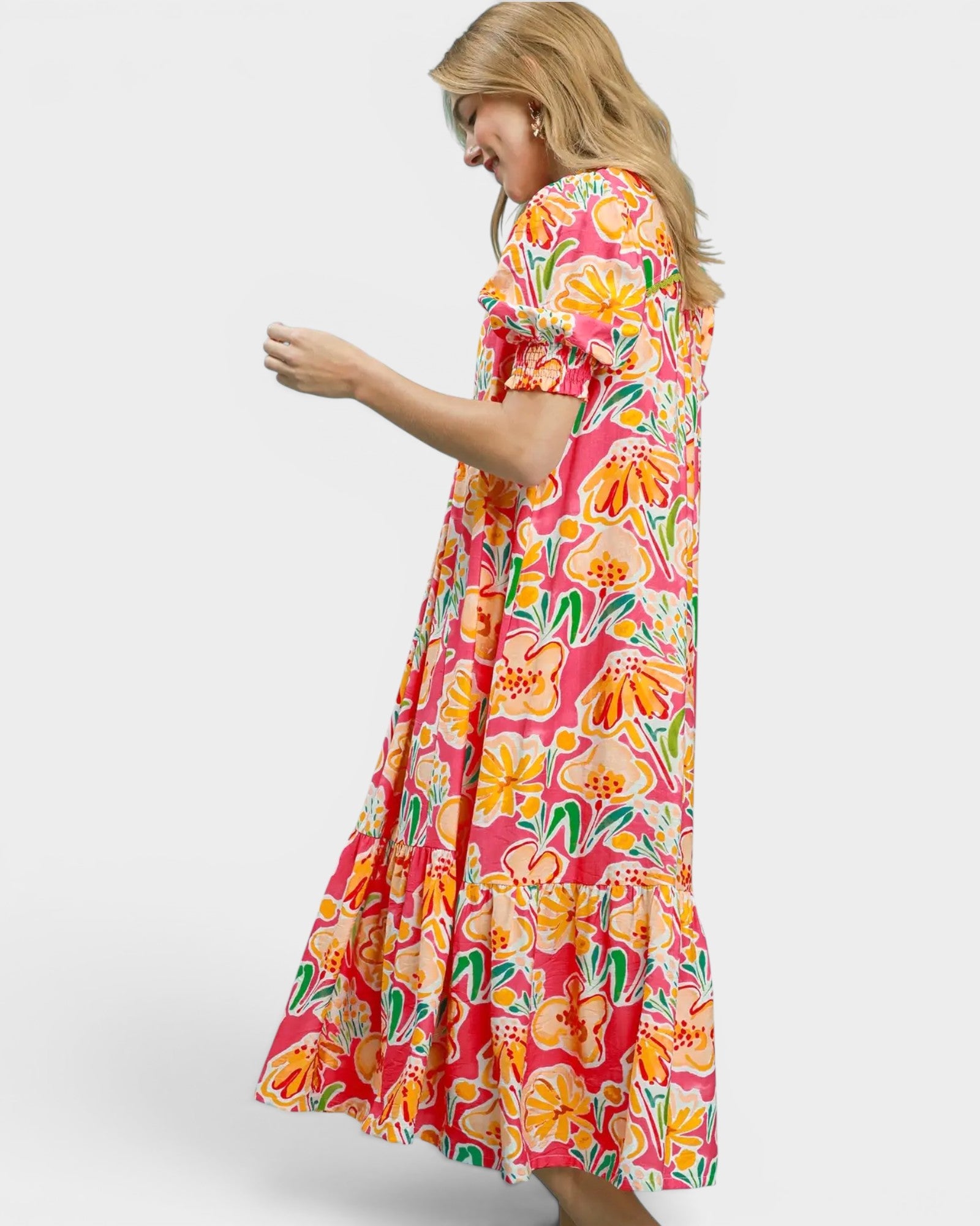 Woman wearing a colorful floral dress on a white background