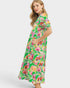 Woman wearing a colorful floral dress on a white background