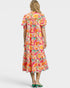 Woman wearing a colorful floral dress on a white background