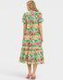 Woman wearing a colorful floral dress on a white background