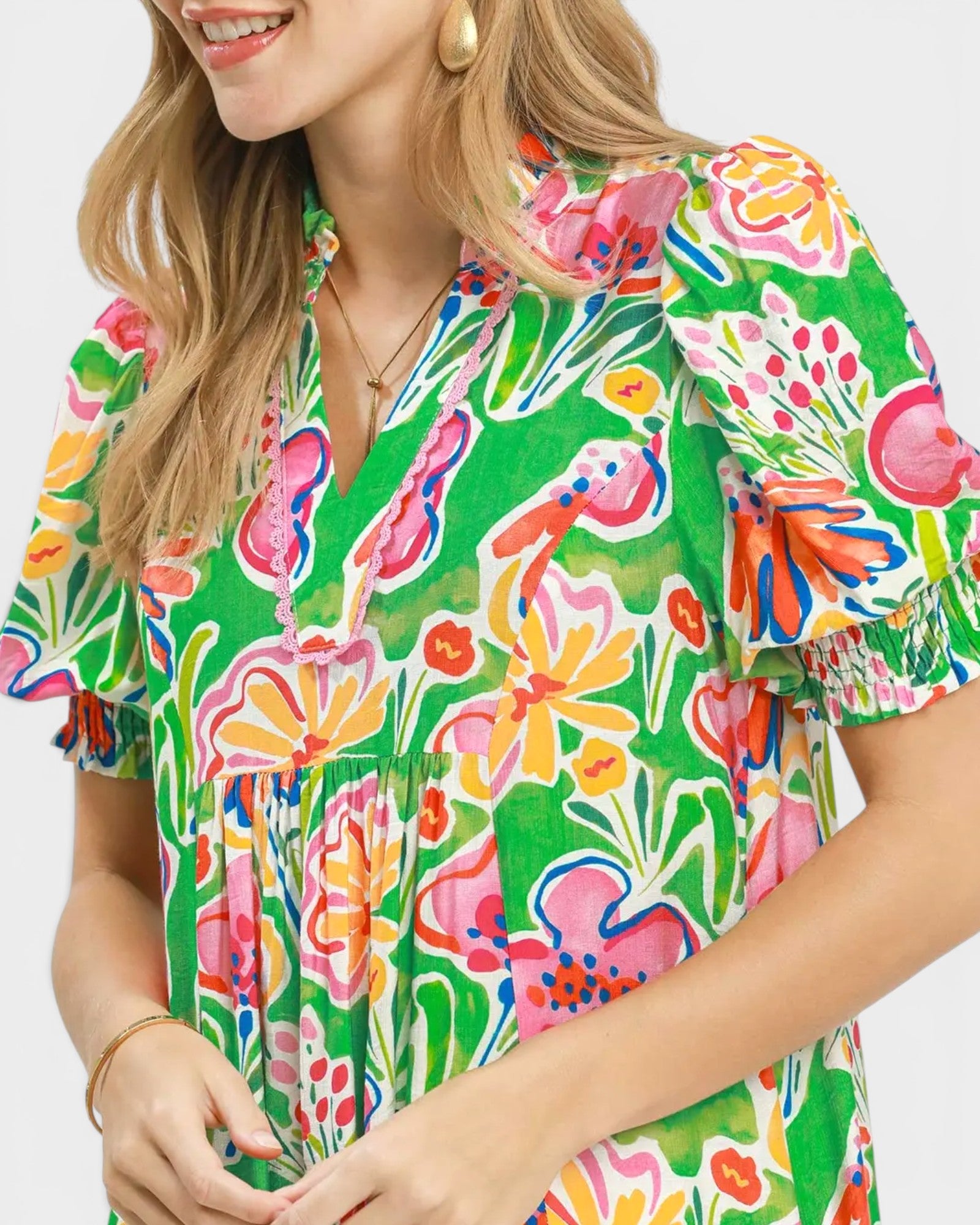 Woman wearing a colorful floral dress on a white background