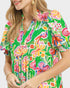Woman wearing a colorful floral dress on a white background