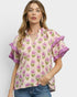 Woman wearing a floral blouse with purple ruffled sleeves on a white background