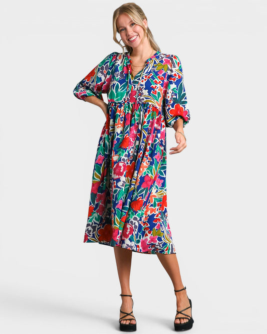 Woman wearing a colorful floral dress on a white background