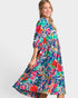 Woman wearing a colorful floral dress on a white background