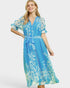Woman wearing a blue floral dress on a white background