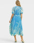 Woman wearing a blue floral dress on a white background