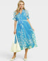 Woman wearing a blue floral dress on a white background