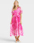 Woman wearing a pink floral dress on a white background