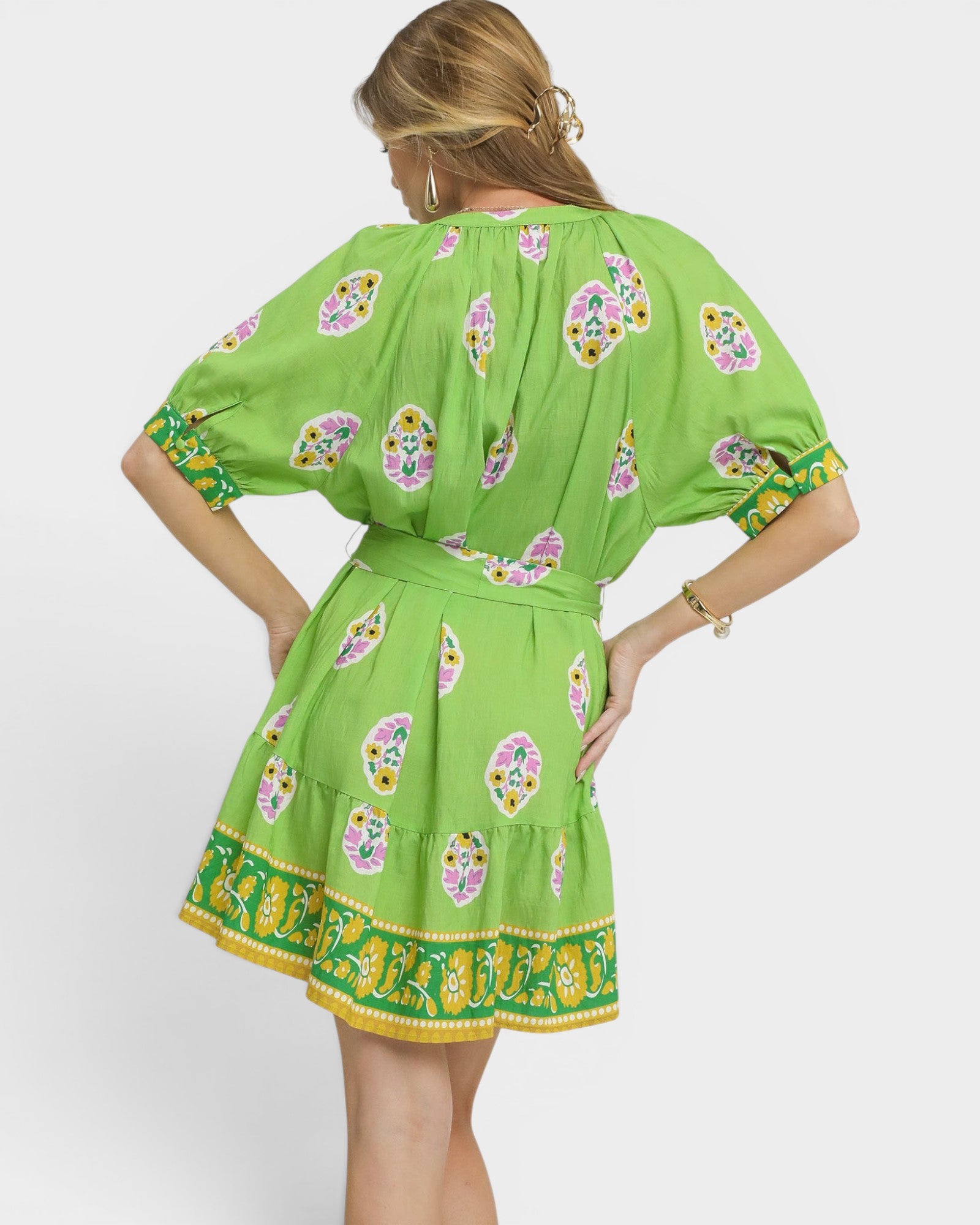 Green dress with floral patterns on a white background