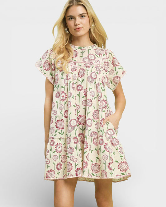 Woman wearing a floral dress on a plain background