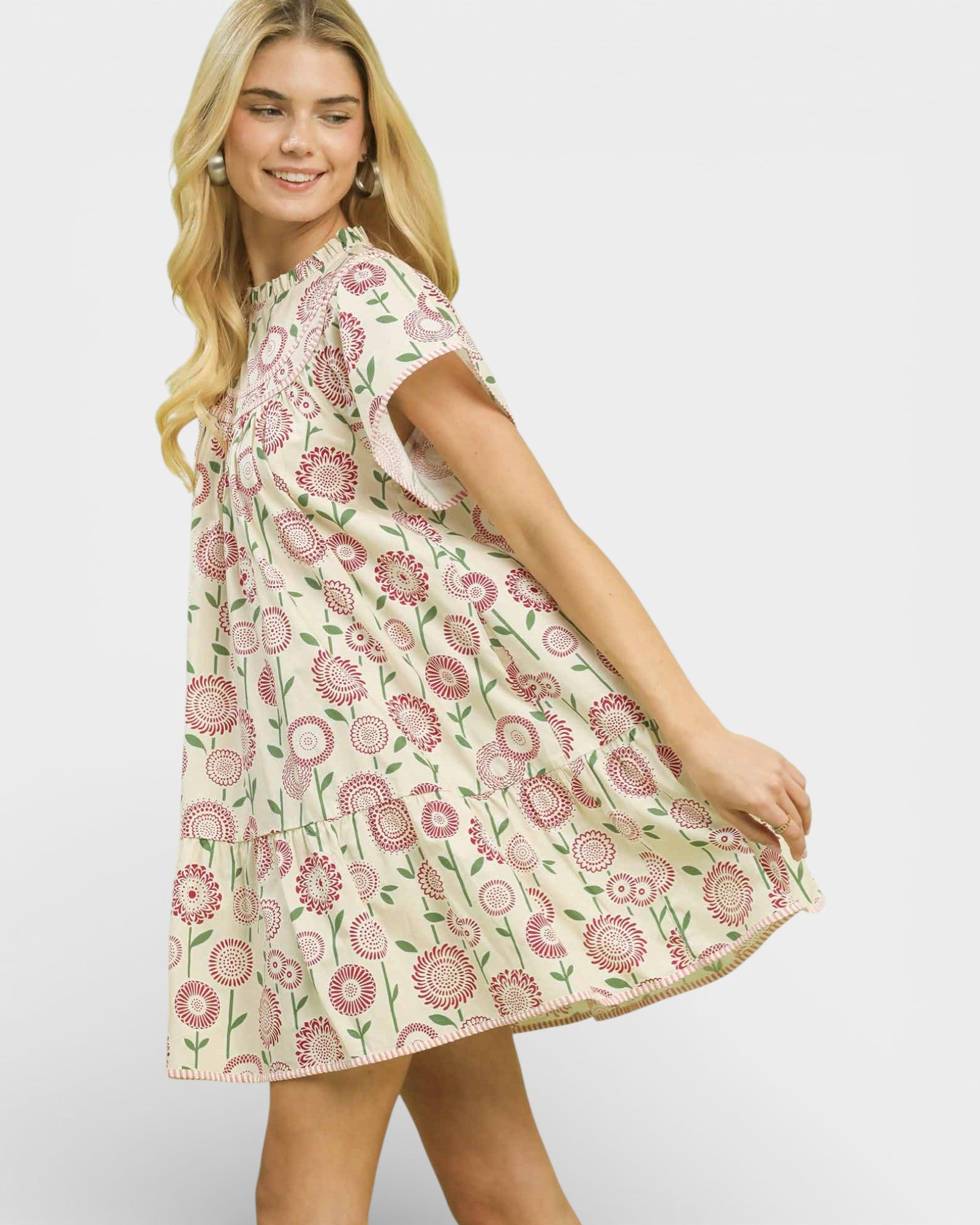 Woman wearing a floral dress on a plain background