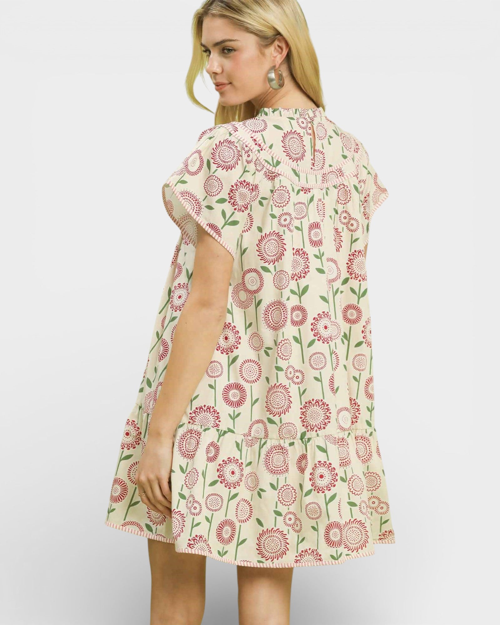 Woman wearing a floral dress on a plain background