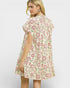 Woman wearing a floral dress on a plain background