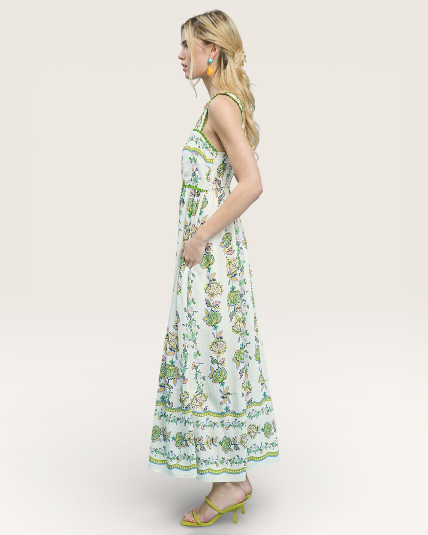 Woman wearing a floral dress on a plain background