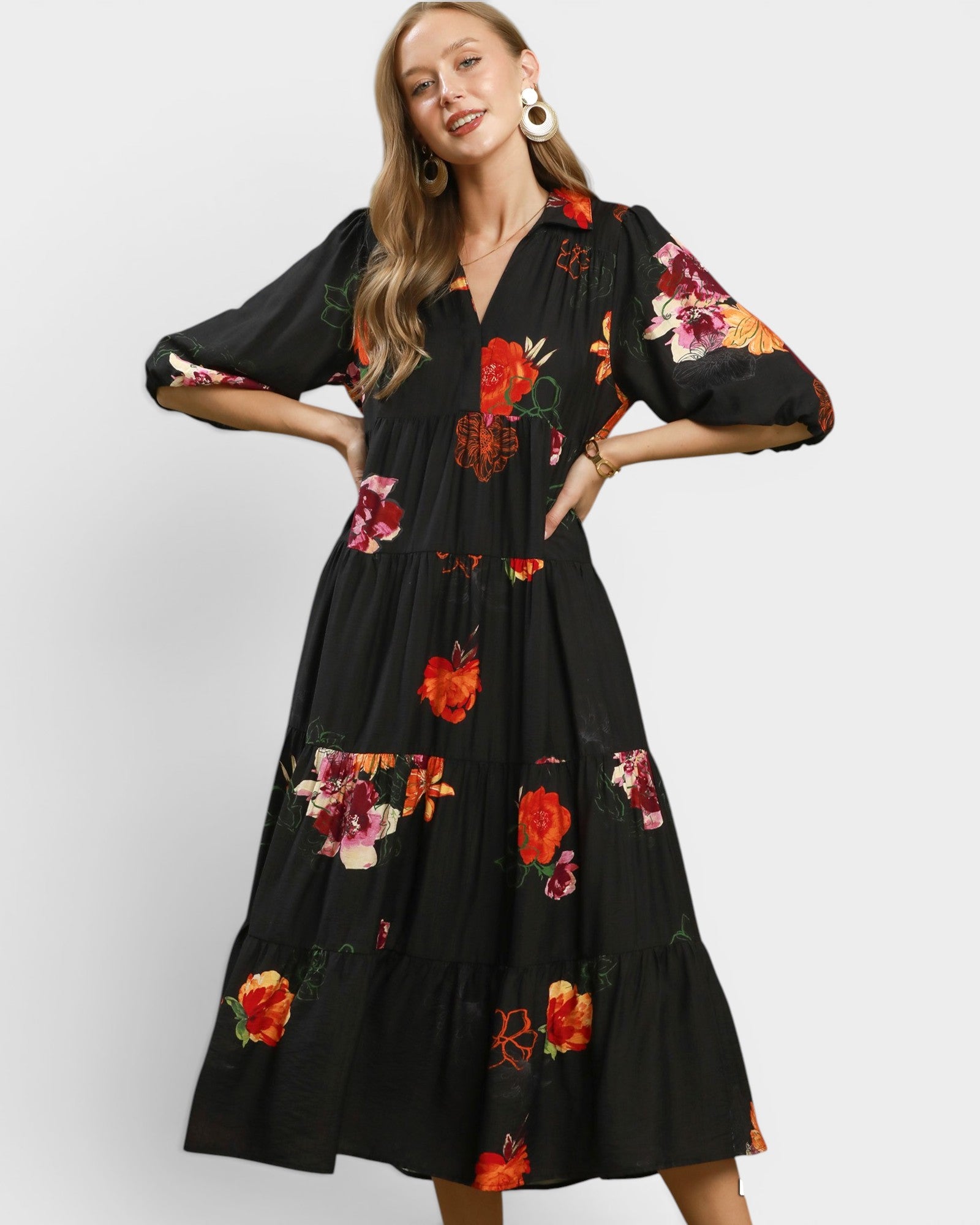 Woman wearing a black floral dress on a white background